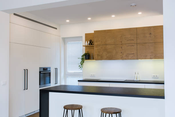 istock Modern kitchen design in light interior with wood accents. 819139470