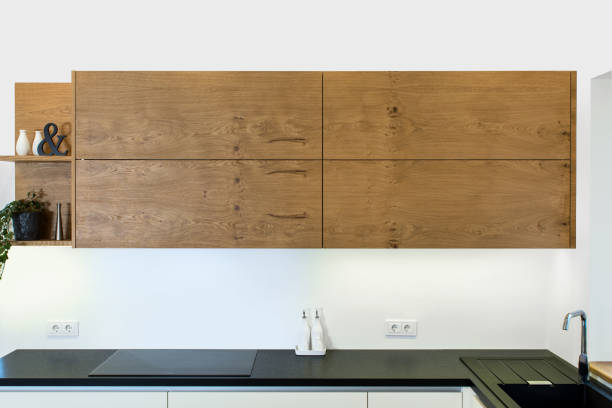 Modern kitchen design in light interior with wood accents.