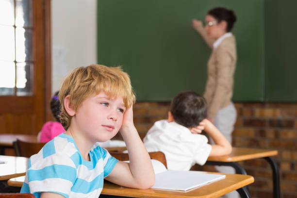 istock Cute pupil not paying attention in classroom 819142708