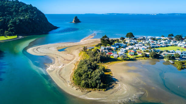 Aerial view on a river mouth with residential suburb on the shore and ocean with small islands on the background. Auckland, New Zealand Waiwera, superb north of Auckland, New Zealand auckland stock pictures, royalty-free photos & images