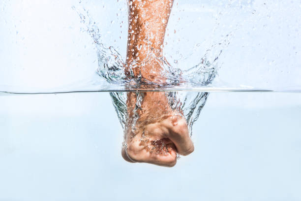 istock Male fist through the water 819178544