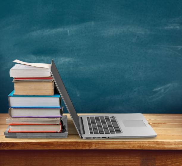 Education. Stack of books with laptop on table classroom empty education desk stock pictures, royalty-free photos & images