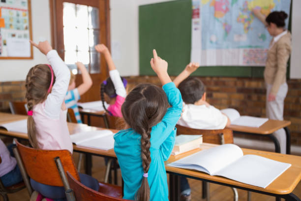 istock Pupils listening to their teacher at map 819183808