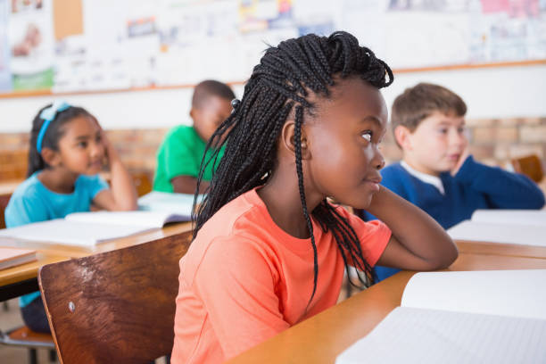 istock Cute pupils listening attentively in classroom 819186390