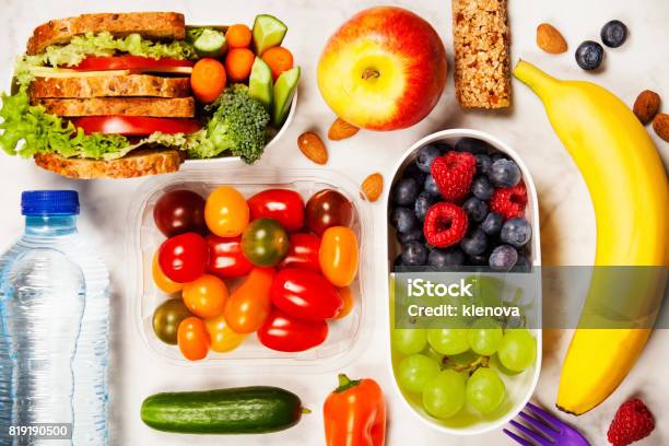 Healthy Lunch Box With Sandwich And Fresh Vegetables Bottle Of Water And Fruits Stock Photo - Download Image Now