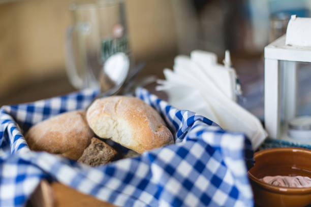istock Fresh warm pieces of bread in brown basket 819191194