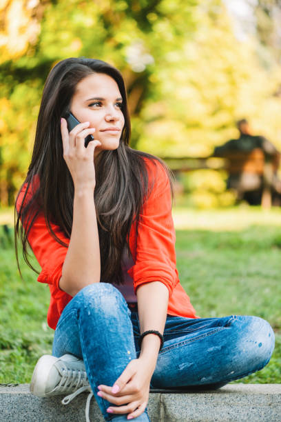 istock Smiling girl with phone 819201150