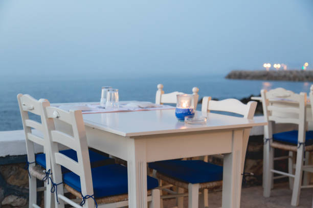 istock Ambient atmospheric evening on Greek coast, white tables in restaurant 819201822
