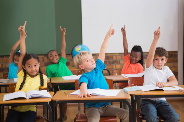 istock Cute pupils raising their hands 819222480