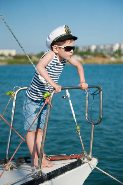 istock Experienced funny little boy captain on board 819248342