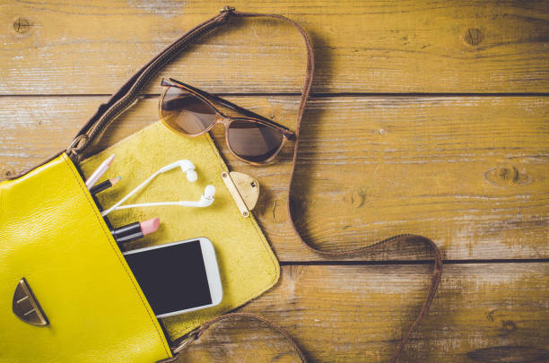 istock Overhead shot of female bag on an old wooden table 819266708