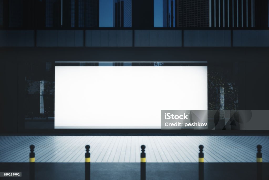 Showcase with empty banner Front view of showcase with empty banner in night city. Advertising concept. Mock up, 3D Rendering Billboard Stock Photo