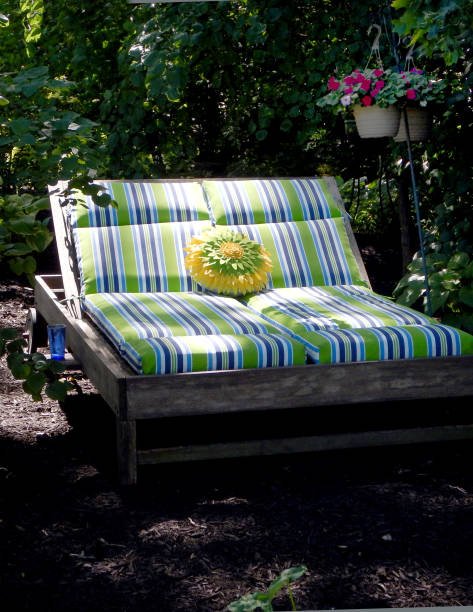 istock Teak chaise lounge in shade area. 819322324
