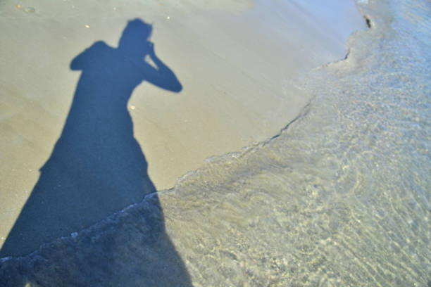 istock Photographer on the beach 819345910