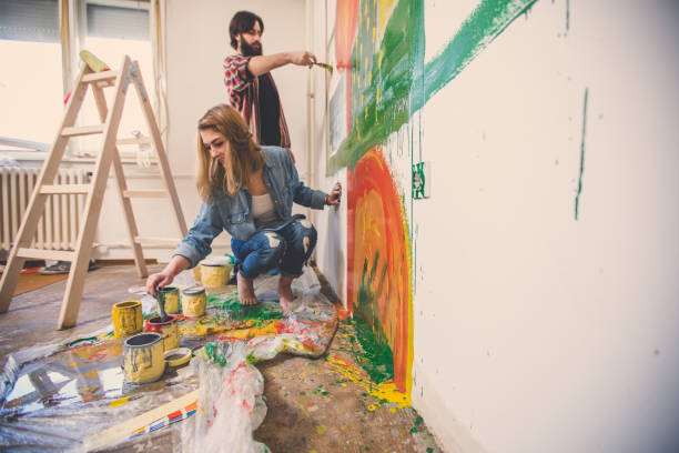istock Couple painting wall 819377870