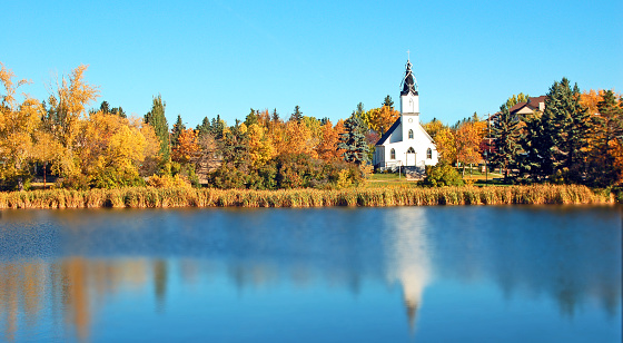 Beautiful autumn scene with white church and autumn colors