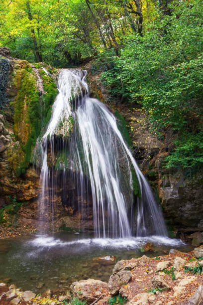 istock Beautiful autumn landscape with waterfall 819381250