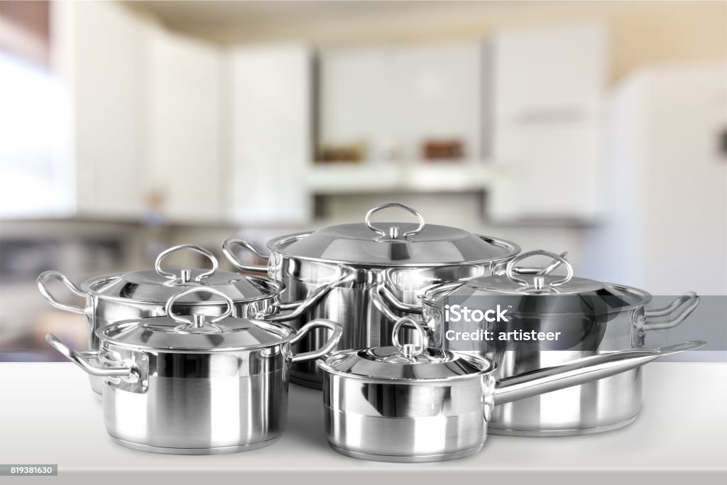 Saucepan. Collection of aluminum pans  on wooden table Stainless Steel Stock Photo