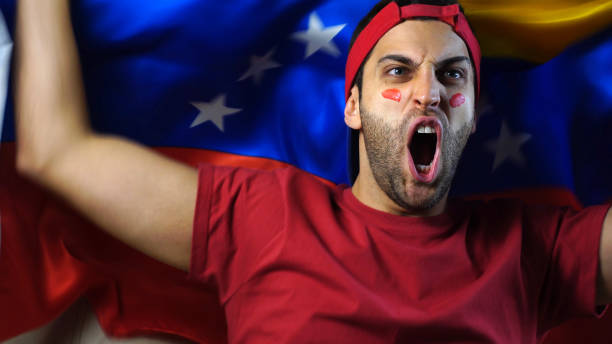 istock Venezuelan Guy Waving Venezuela Flag 819381644