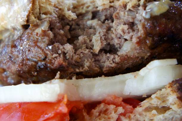 istock Thick Juicy Hamburger with a Bite Out of It. 819397278
