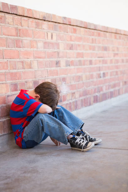 istock Sad pupil sitting alone in corridor 819400206