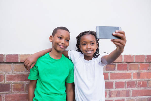 istock Cute pupils taking a selfie in the corridor 819402422