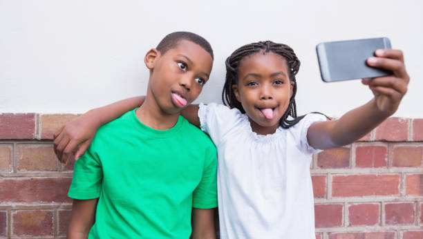 istock Cute pupils taking a selfie in the corridor 819402428
