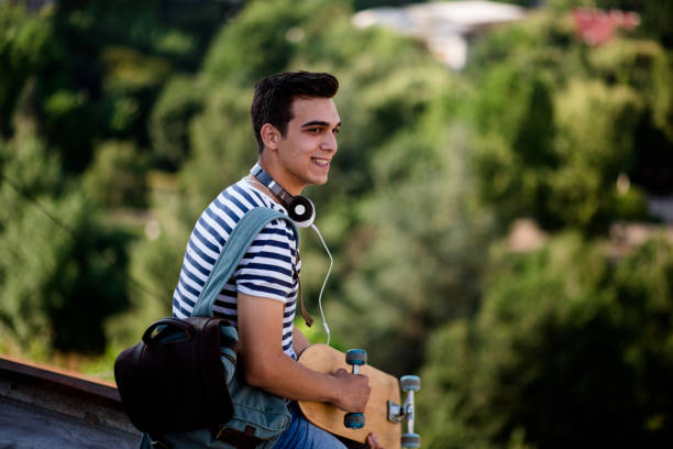 istock Happy Young Man Relaxing On Top Of Building 819405474
