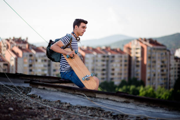 istock Brave Skater Sitting On Top Of Building 819405528