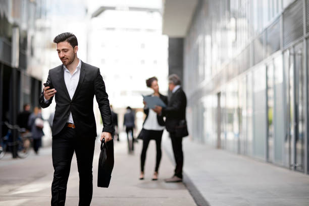 istock Business people walking downtown business district 819410178