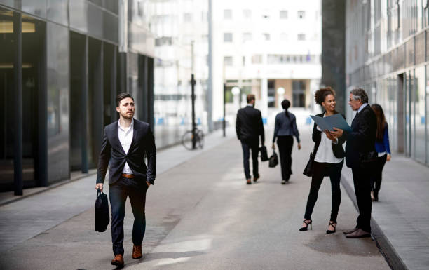 istock Business people walking downtown business district 819410396