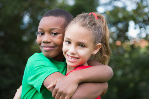 istock Cute children smiling at camera outside 819410574