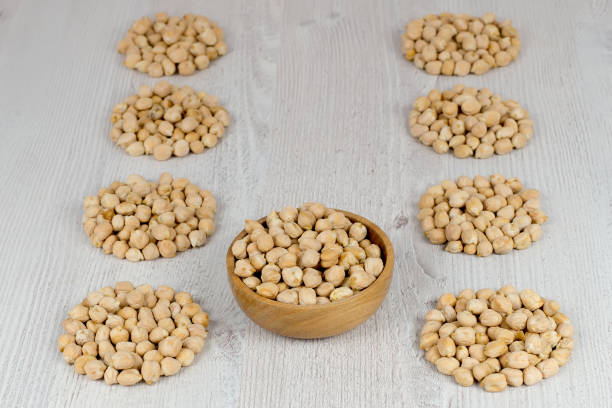 istock Chickpeas in a wooden bowl and orderly circles. 819414840