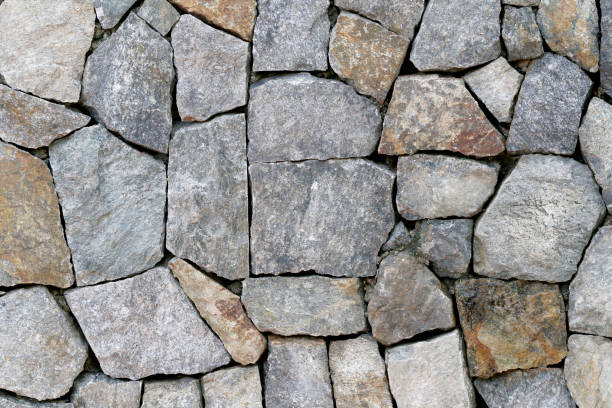 istock Old stone wall Texture in weathered and have natural surfaces for design background. 819424676