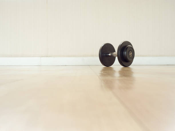 istock Dumbell left alone on the gym floor. 819425308