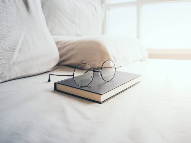 istock Eyeglasses and book in bedroom for reading and relax. 819425322
