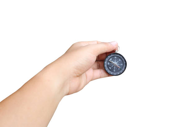 istock hand of a man holding a compass on white background and have clipping paths to easy deployment. 819429564