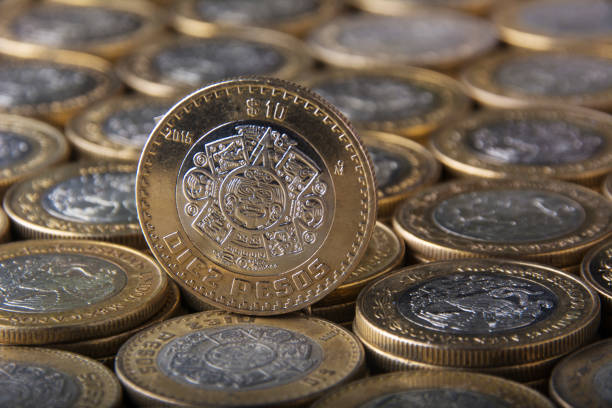 istock 10 Mexican pesos coin on many aligned and applied coins 819445672