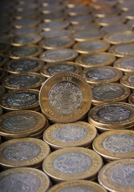 istock 10 Mexican pesos coin on many vertical aligned and applied coins 819445836