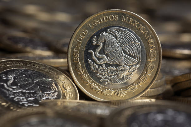 istock Mexican currency in front a background of coins, Horizontal 819448778