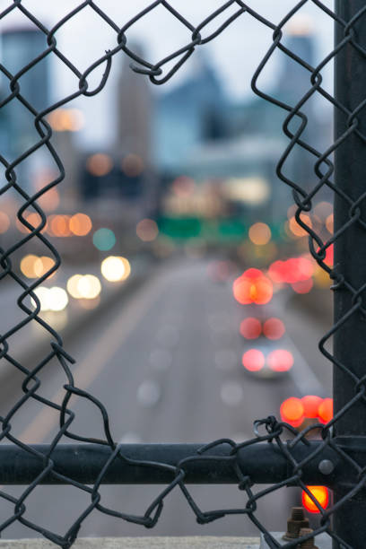 istock Minneapolis Traffic Light Trails and Skyline through Fence 819449080