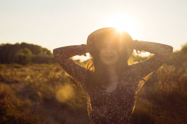 Young beautiful boho woman at sunset
