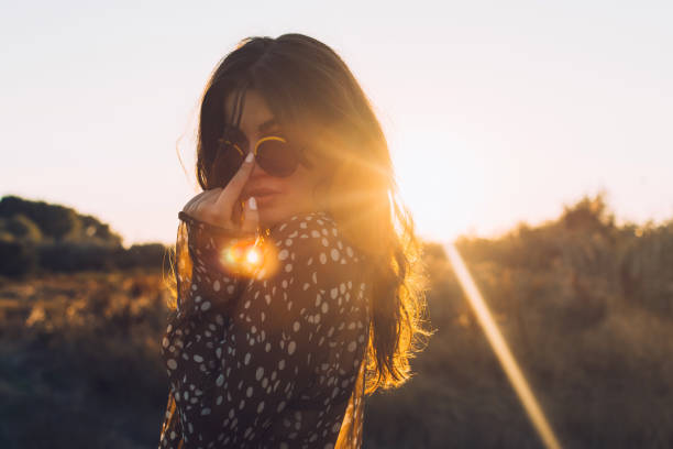Young beautiful boho woman at sunset
