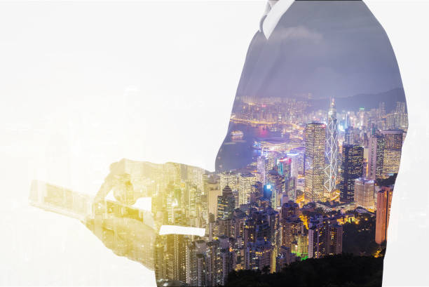 istock Double exposure of businessman using the tablet against city 819453852