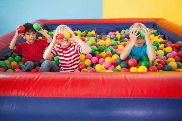 istock Happy children playing in ball pool 819456950