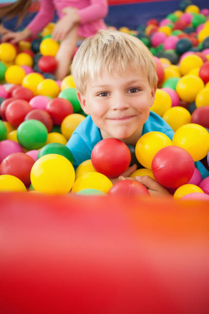 istock Happy boy playing in ball pool 819456954