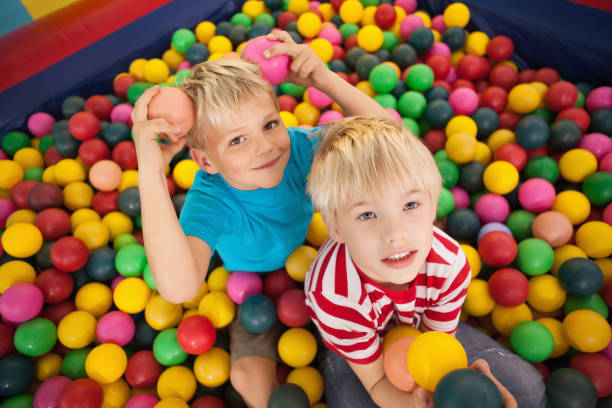 istock Happy children playing in ball pool 819457024