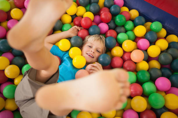 istock Happy boy playing in ball pool 819457074