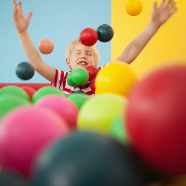 istock Happy boy playing in ball pool 819457164