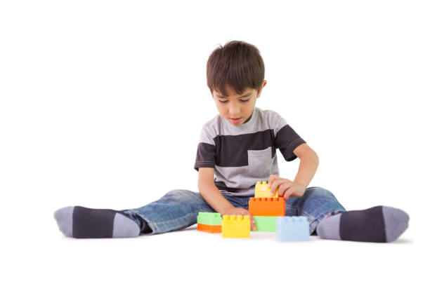 istock Happy little boy playing with building blocks 819464346